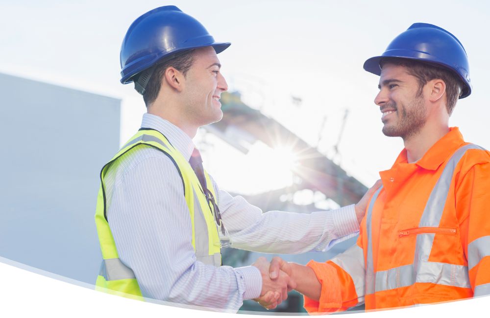 2 men in hard hats shaking hands