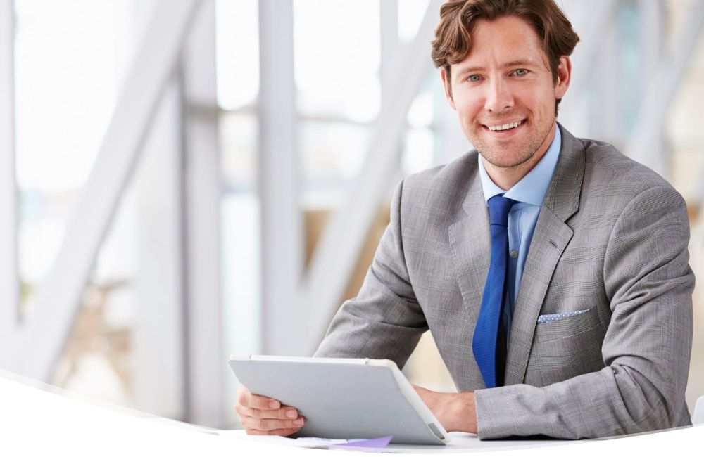 business man smiling with tablet