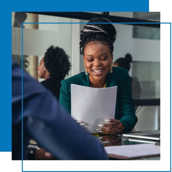 woman looks at paper resume