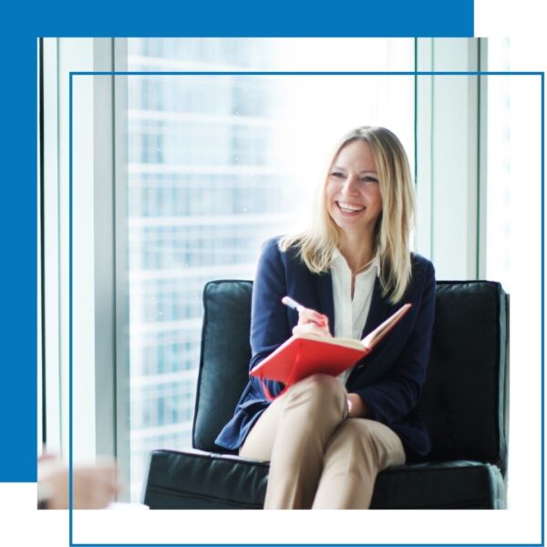 woman sits in chair in high rise building 